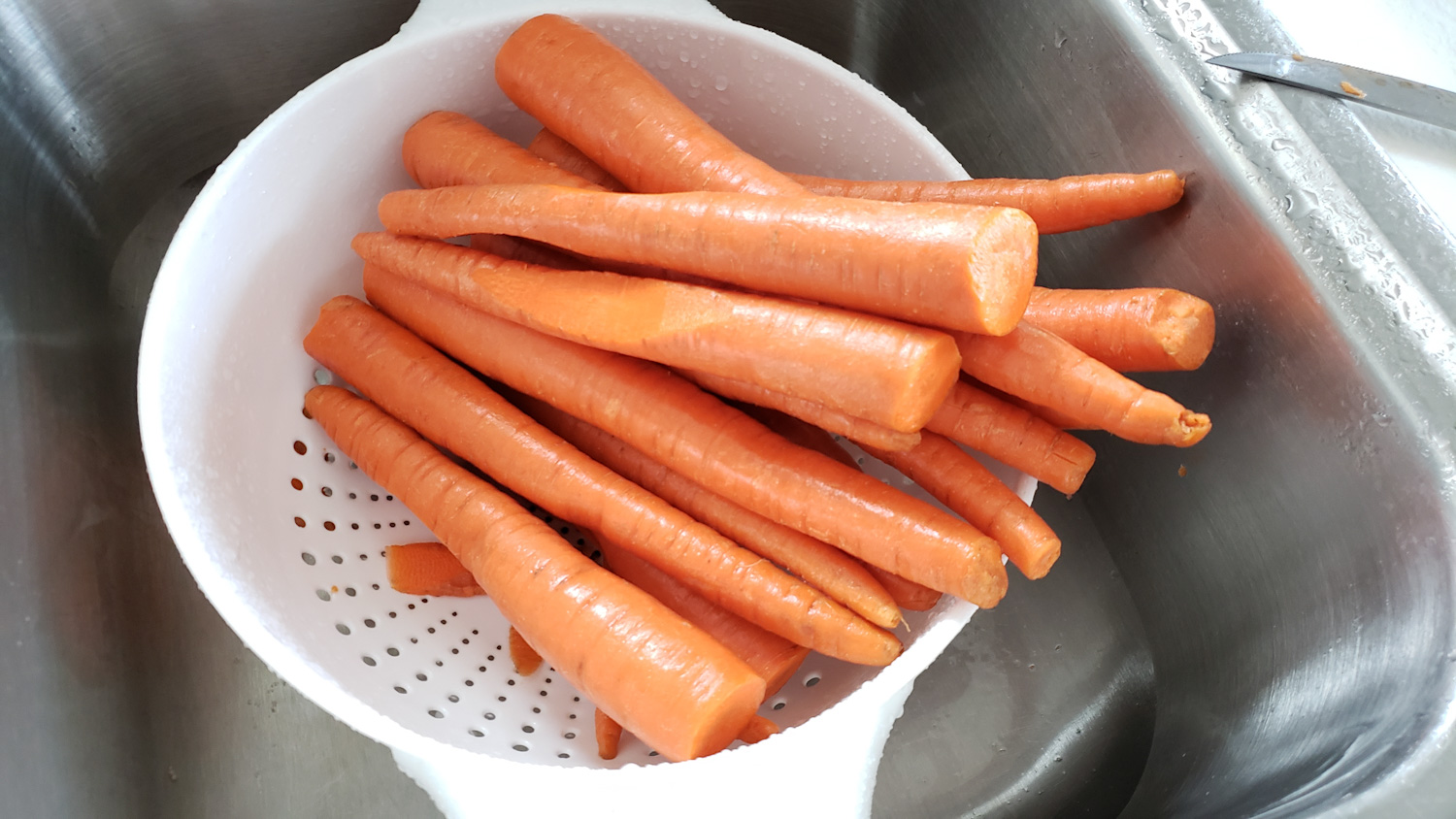 raw carrots getting cleaned