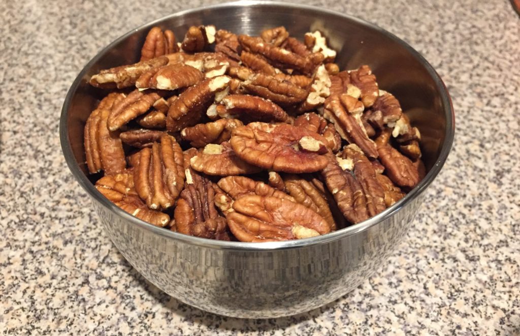 Raw Pecans in stainless bowl