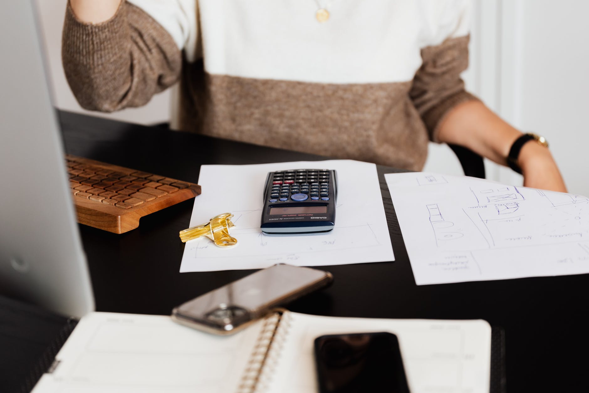 Woman using calculator how to pay your high energy bill