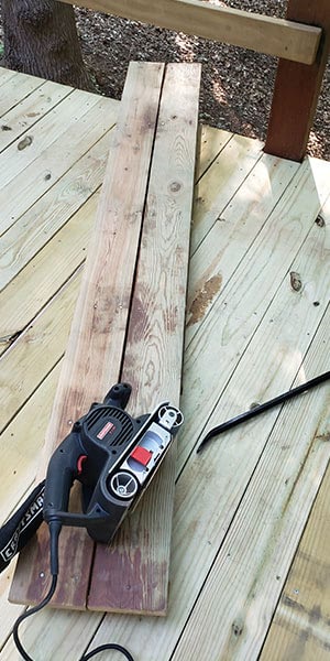 Sanding a deck step