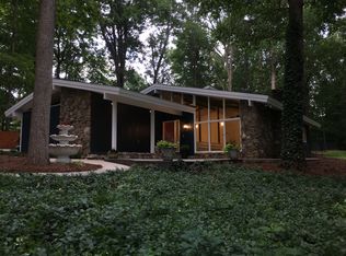 1973 Mid-Century Modern house at dusk - lights turned on inside