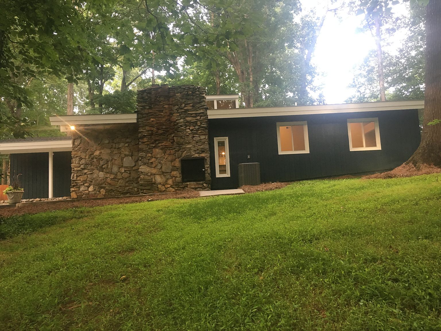 House Tour: Period Perfection 1973 Mid-Century Modern 5 1973 Mid Century Modern Outside Fireplace stone