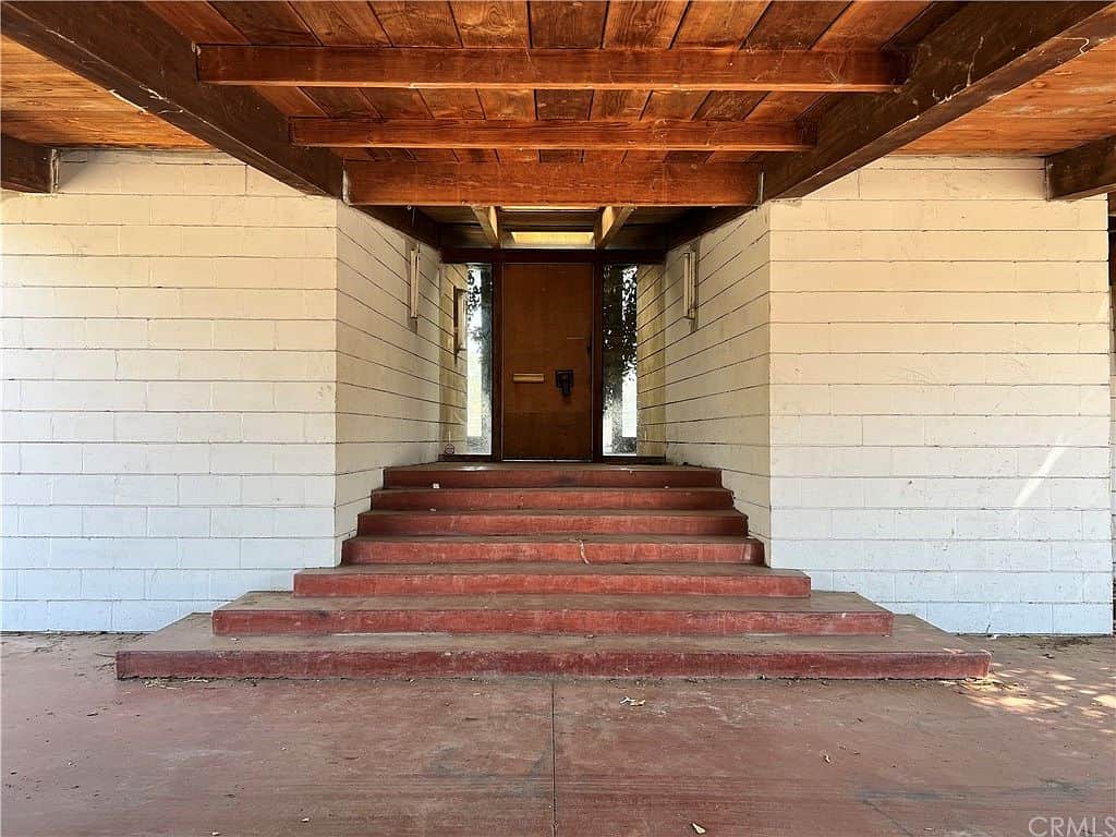 Carport and entrance to house center and skylight