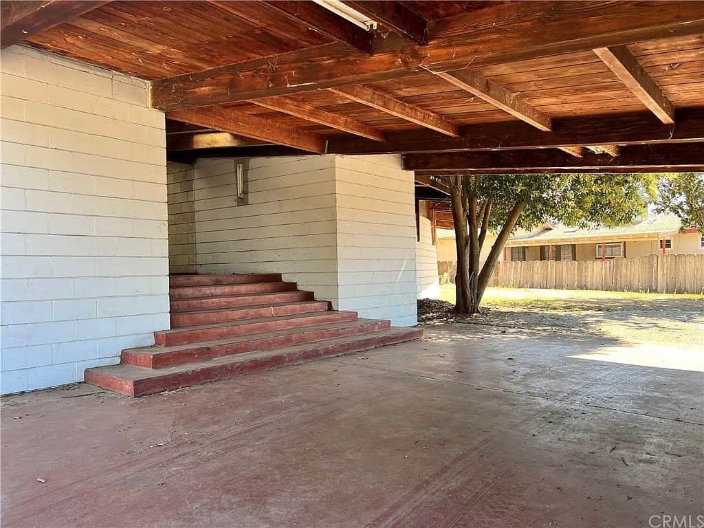 Carport and entrance to house left