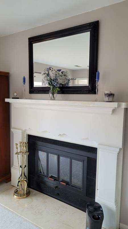 How To: Add A Mantel to a Bedroom Fireplace finished side angle black mirror and fireplace