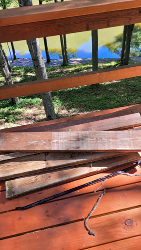 Pile of old wood planks and 3 foot crowbar