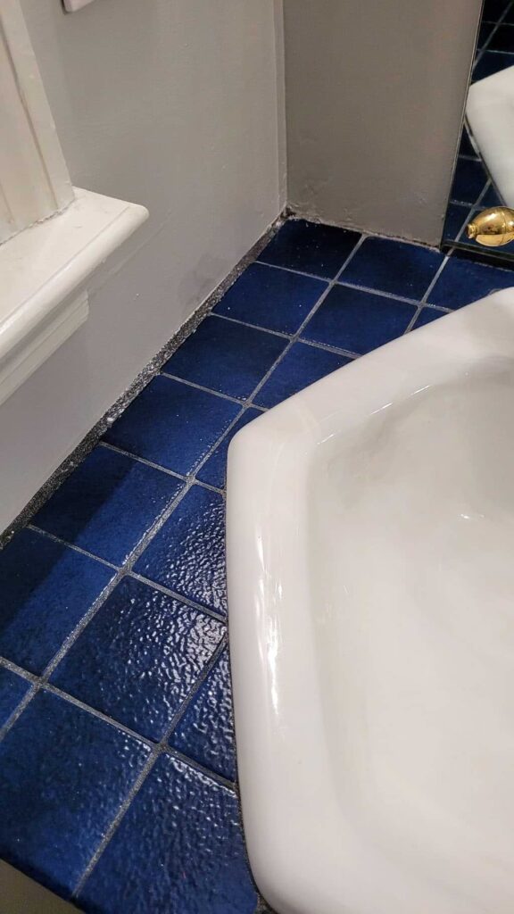 How to Restore or Change Stained Grout Color in Seconds 19 Black Grout stained in a Mid Century Modern Bathroom next to sink 1