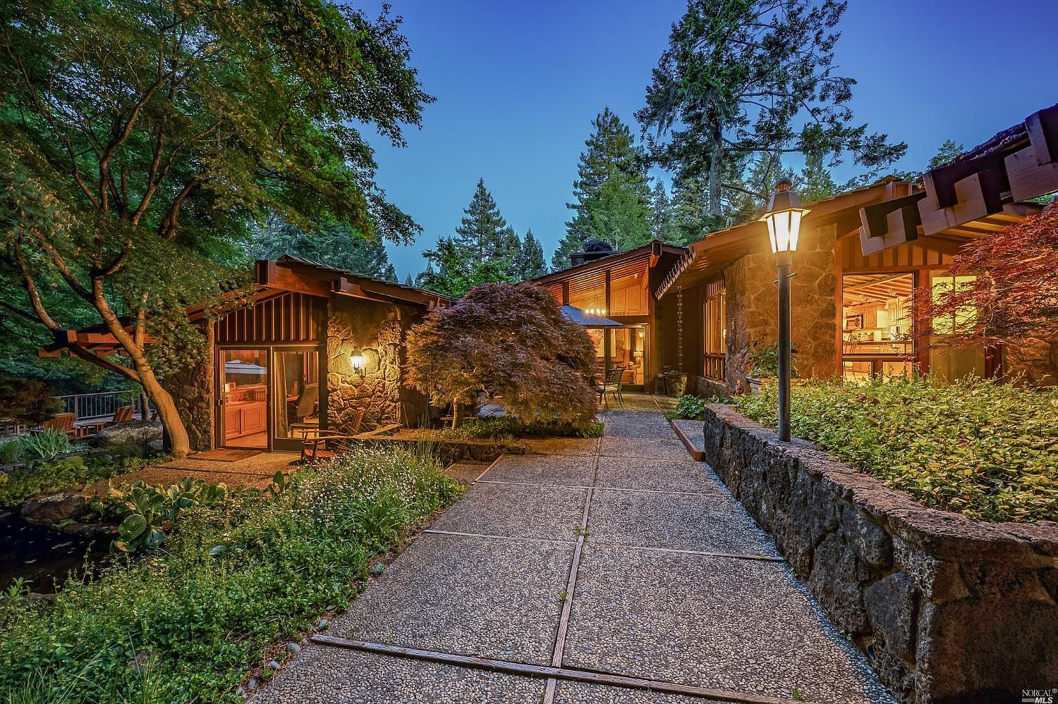 Mid-Century at night with concrete walkways and large trees
